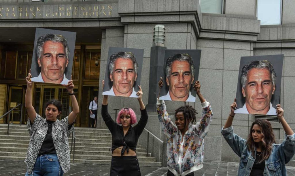  A protest group hold up signs of Jeffrey Epstein in front of the federal courthouse on 8 July 2019 in New York City. Photograph: Stephanie Keith/Getty Images