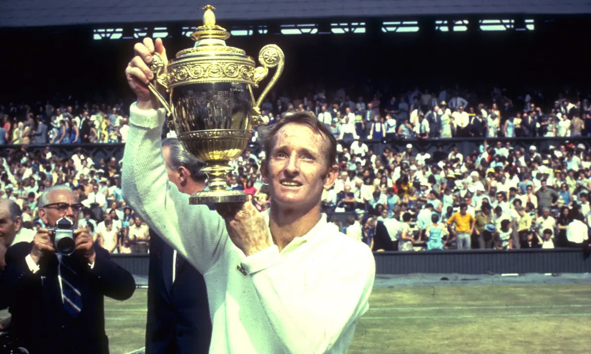 Rod Laver holding the 1968 Wimbledon Men's Singles Champion trophy. He would go on to win each of the other three Grand Slam Tournament in that year,